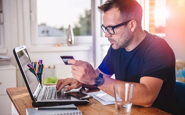 Consumer paying with credit card for his online order